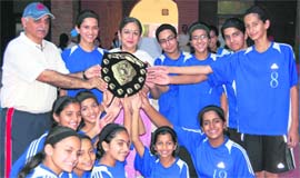 Welham girls receive the trophy after winning the District Sub-Junior (u-14) Basketball Championship in Dehradun on Sunday.