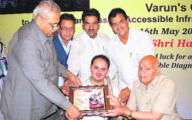 Vidhan Sabha Speaker Harbans Kapoor felicitates Varun Jain in Mussoorie on Sunday.