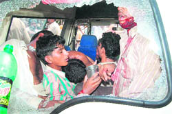 Buffalo thieves, who were beaten up by villagers, in a police Gypsy at Buwan in Fatehabad 