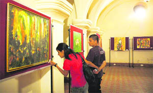 Onlookers appreciate a painting exhibition organised by the Himachal Art Heritage Society at Gaiety Theatre in Shimla on Sunday.