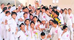 Winners in a jubilant mood after winning the karate championship in Ludhiana on Sunday.