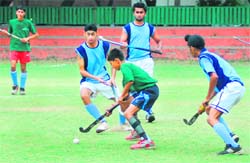 Players vie for the ball during a match at the Hockey Stadium, Sector 18, Chandigarh, on Monday. 