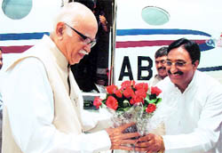 Advani being received by Nishank at the Jolly Grant airport near Dehradun on Monday
