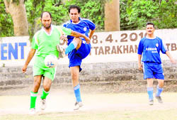 Players vie for the ball during a match at the Second Institutional League Football Tournament in Dehradun on Monday