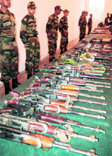 Army soldiers display arms and ammunition seized from a militant hideout at an Army base in Sahrifabad, Budgam. The cache was seized during a search operation in Kupwara district on Monday.