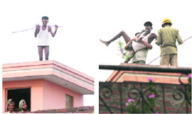 A drunk man tries to commit suicide by jumping from the third floor of a house at Trikuta Nagar in Jammu on Monday; and (right) a police team rescues him.