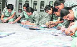 Students of Green Land Senior Secondary Public School participate in collage making competition on the theme of "Save water' in Ludhiana. 