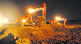 Desilting work at the regulator end of the Sukhna lake in full swing on Tuesday night.