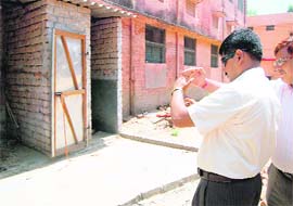 District Magistrate Dr Meenakshi Sundaram clicks a photograph of a public toilet.