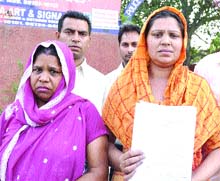 Victim Naresh Rani shows orders of a Sessions Judge in Jalandhar