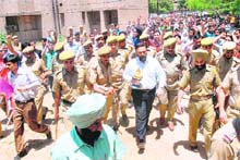Agitating students trying to gherao the Vice-Chancellor of Jammu University, Prof Varun Sahni, in Jammu on Wednesday. 