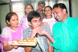 Ishan Koul celebrates his success along with his parents at his home in Nanak Nagar, Jammu, on Wednesday.