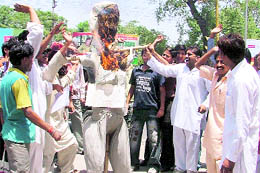 Activists of the Bharatiya Balmiki Samaj Morcha burn an effigy of UP Chief Minister Mayawati at the Mini Secretariat in Ludhiana on Wednesday