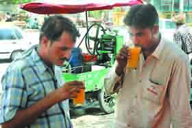 Men sipping bael fruit drink to cool off in Bathinda on a hot Thursday afternoon. 