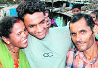 Jagdamba, a rickshaw-puller’s son, who has secured 80 pc marks in CBSE class XII, is flanked by his mother and father at his residence in Industrial Area, Chandigarh, on Thursday.
