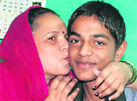 Suraj, who secured 80.4% marks, with his mother
