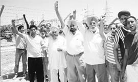 Villagers protest against the shifting of the main transformer at Mauli Baidwan village on Thursday.