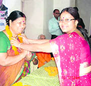 State Women Congress president Sarojini Kaintura being garlanded by local unit officials in Mussoorie