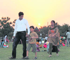 People enjoy an evening at Atal Park in Karnal