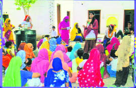 NGO volunteers interact with village women at Jatusana village in Rewari district.