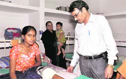 Dr SK Gupta, ortho surgeon, Doon Hospital, examines a young patient.