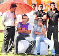 Cricketer Irfan Pathan enjoys his moment in the shade while attending trials in Ludhiana on Frida