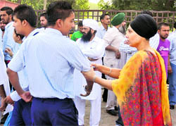 A student being stopped by a teacher from joining a dharna at Nankana Public School in Ludhiana on Friday