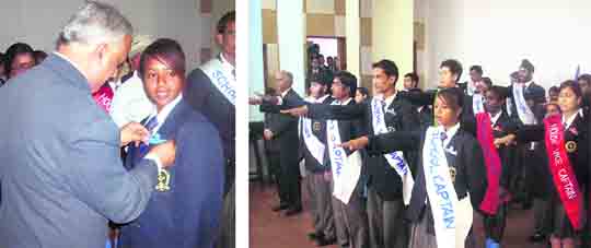 Anisa Saleh, school captain of Mussoorie Public School, being pinned a badge by the chief guest and (right) other elected students take oath at an investiture ceremony on Saturday.