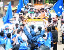 APHC chairman Mirwaiz Umar Farooq, along with other senior Hurriyat leaders, wave to party supporters during a procession held to commemorate the killings of Mirwaiz Mohammad Farooq and Abdul Gani Lone, at Handwara on Saturday. 