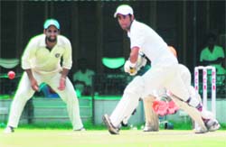 A player plays a shot during a cricket match in Mohali on Sunday.