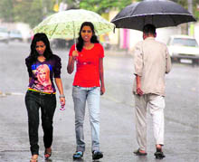 Two girls enjoy an evening downpour in Dehradun on Sunday