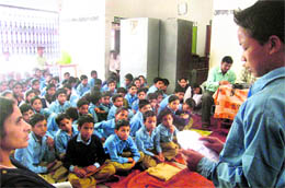 A government school student reads an essay on bio-diversity conservation at Maroda village in Tehri Garhwal on Sunday