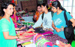 Tourists at a handicraft stall in Mussoorie.