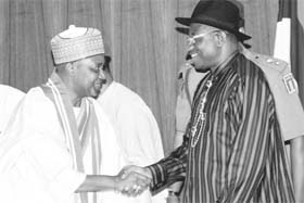 Nigerias President Goodluck Jonathan (R) congratulates the new Vice President, Namadi Sambo, on May 19.