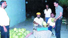 Kamaljit Singh sells watermelons at his stall in Nakodar.