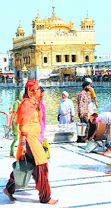 Devotees perform sewa inside the Golden Temple complex in Amritsar on Sunday.