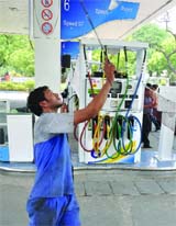 A petrol pump employee plays badminton during the petrol pump dealers' strike in New Delhi on Monday.