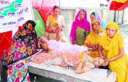 Women attend to fellow protesters who fainted at the agitation spot in Haridwar 