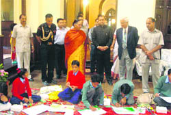 Governor Margaret Alva looks at participants of a painting contest at the Nainital Raj Bhawan
