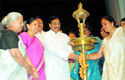 Chief Minister Ramesh Pokhriyal Nishank lights the lamp at a function in Dehradun on Monday