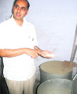 Chander Prakash, deputy commissioner, checks food material used in preparation of mid-day meal at Government Secondary School, Paharipur village, in Jhajjar