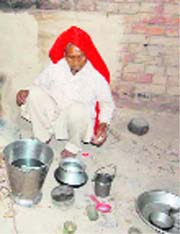 Sona Devi cooks a meal in Mirchpur village of Hisar on Monday.