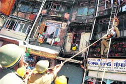 Rescue workers performing an earthquake mock drill at the Ganj Bazaar in Shimla on Monday.