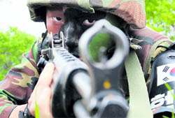 A South Korean soldier conducts a military drill near the demilitarised zone separating South Korea from North Korea in Yanggu, about 180 km northeast of Seoul, on Monday