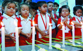Nursery students pray for the departed souls of ill-fated Air india aircraft at Mangalore in 
