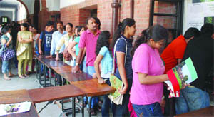 Students and parents queque in to take admission forms at St Stephen's College in New Delhi on the opening day on Tuesday.