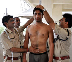 A candidate undergoes a measurement test during a recruitment drive for the 4th Indian Reserve Battalion at Devi Lal Stadium in Gurgaon on Tuesday.