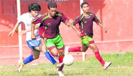 Players vie for the ball at the Narendra Singh Kharola Memorial Football Tournament in Dehradun on Tuesday.
