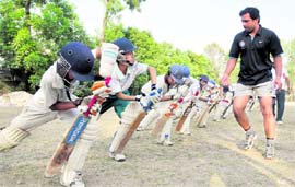 Young players get tips at a coaching camp in Dehradun on Tuesday.