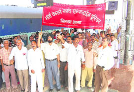 Railway staff hold a protest at Sirsa Railway Station on Tuesday.